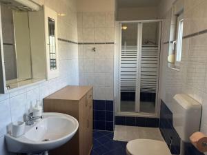 a bathroom with a sink and a shower and a toilet at Medulin Burle A4 1 in Medulin +20 photos