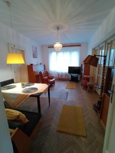 a living room with a table and a couch at Garden Apartman Malvazinky in Prague