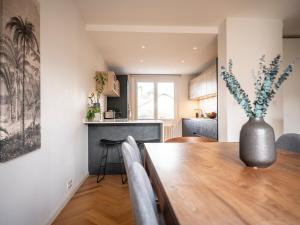 a kitchen and dining room with a vase on a table at Venez Chez Vous Villa Singa in Annecy