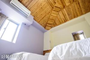 Postel nebo postele na pokoji v ubytování 好馨情民宿