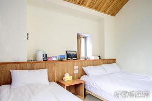Postel nebo postele na pokoji v ubytování 好馨情民宿 + 9 fotografií