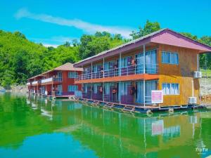 a row of buildings on a body of water at Phupai Lake Resort in Ban Wang Khun Knachen