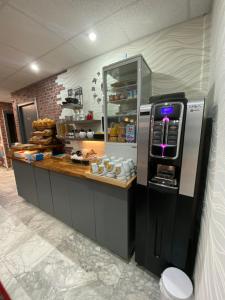 a kitchen with a counter with aasteryasteryasteryasteryasteryasteryasteryasteryastery at Savoie Hotel aux portes de Genève in Saint-Julien-en-Genevois