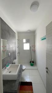 a white bathroom with a sink and a toilet at Fouka bay chalet at north coast, Egypt in Marsa Matruh