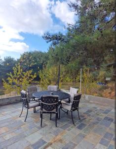 a patio with a table and chairs on a patio at Butterfly Home in Platres
