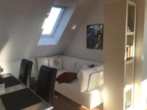 a living room with a white couch and a table at Ferienwohnung Schmidbauer in Beilngries