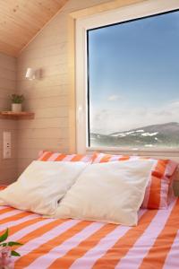 a bed in a room with a large window at Aurora Green Hill in Podobin
