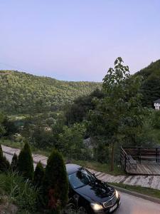 a car parked on a road with a hill at Studio Apartment in Bihać +3 photos