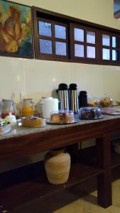 a kitchen counter with a table with food on it at Hotel Navegantes Beach in Fortaleza