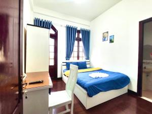מיטה או מיטות בחדר ב-Dona Dalat Hotel