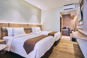 Katil atau katil-katil dalam bilik di Grand Palma Pangandaran by Horison