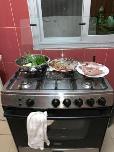 a stove with three plates of food on top of it at Chez saly in Saint-Louis