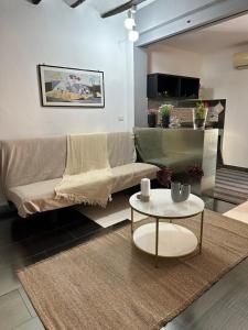 a living room with a couch and a table at Civico168 in Castellammare del Golfo