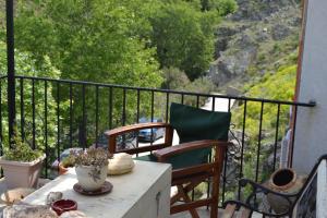 a balcony with two chairs and a table with a view at Gattilusi View Cottage in Samothraki