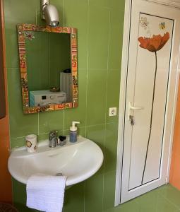 a bathroom with a sink and a mirror at Gattilusi View Cottage in Samothraki