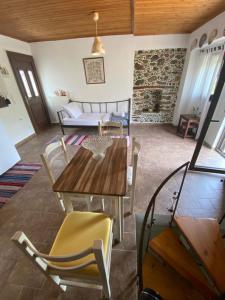 a living room with a wooden table and chairs at Gattilusi View Cottage in Samothraki
