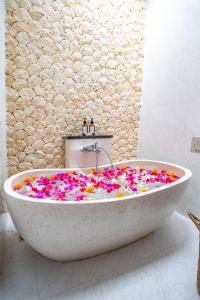 a bath tub covered in confetti in a bathroom at A12 - Private Villa in Seminyak - Big Pool - ALL NEW in Seminyak