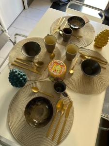 a table with plates and utensils on it at Civico168 in Castellammare del Golfo +9 photos