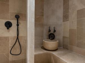 a shower with a bath tub with a shower head at Radisson Blu Hotel, Kas in Kaş