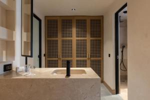 a bathroom with a sink with a black faucet at Radisson Blu Hotel, Kas in Kaş