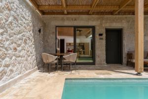 a patio with a table and chairs and a pool at Radisson Blu Hotel, Kas in Kaş