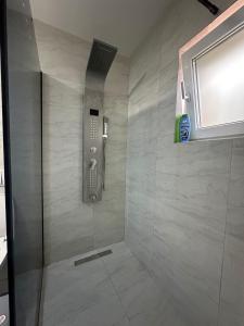a bathroom with a shower with a phone at Villa Ozoni 2 - Jezerc in Ferizaj