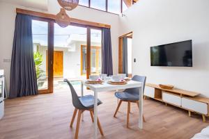 a dining room with a white table and chairs at A12 - Private Villa in Seminyak - Big Pool - ALL NEW in Seminyak
