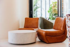 two chairs and a coffee table in a room at Pacha Hotel in Ibiza Town