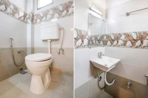 a bathroom with a toilet and a sink at FabHotel Ratna Palace in Ahmedabad