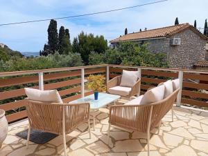 a patio with chairs and a table on a balcony at Green Olive House in Agios Nikolaos