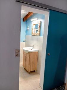 a bathroom with a sink and a blue wall at Green Olive House in Agios Nikolaos
