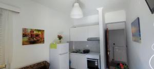 a small kitchen with a white refrigerator and a sink at Top Holidays Apartments in Chania +18 photos