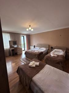 A bed or beds in a room at Kazbegi Guide