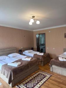 A bed or beds in a room at Kazbegi Guide