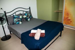 a bedroom with a bed with two towels on it at Fijian Homestay - 3 bedroom house in Nadi
