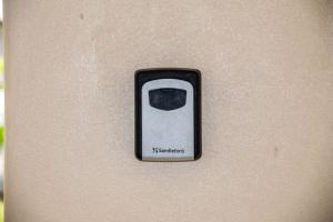 a close up of a cell phone on a wall at Fijian Homestay - 3 bedroom house in Nadi