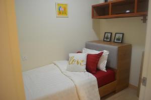 a bedroom with a bed with a love sign on it at Munchkin Seafront Residence bossku in Kuantan +27 photos