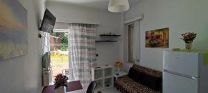 a living room with a couch and a window at Top Holidays Apartments in Chania
