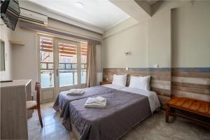 a hotel room with a bed and a television at Bikakis Family Apartments in Kissamos