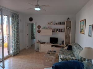 a living room with a couch and a tv at Vera Natura Apartamento Angela in Playas de Vera