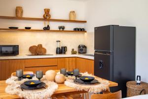 a kitchen with a wooden table and a refrigerator at Best Place by walking, Beach, Brand NEW Villa, Canggu in Kerobokan