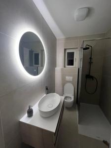 a bathroom with a sink and a mirror at Art Apartment Mali Losinj in Mali Lošinj