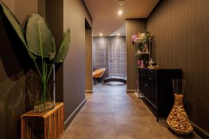 a hallway with a vase and a plant in a room at Hotel Cristal Park in Tarnów +93 photos