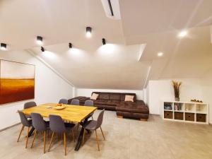 a living room with a table and a bed at Stadion apartments Izola in Izola