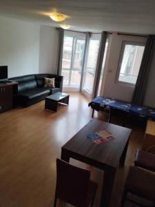 a living room with a couch and a table at Sea Garden Burgas in Burgas City