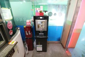 a video game machine in a room with a door at Busan Station Centum Hotel in Busan