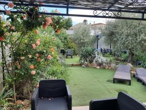 a patio with chairs and a garden with flowers at Eclats du Sud in Auriol