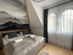 una camera con due letti e una grande finestra di VisitZakopane - Radowid Loft Spa Apartment a Zakopane