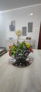 a vase filled with flowers sitting on a table at Casa vacanza Agrippina in Bacoli