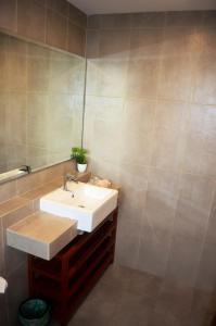 a bathroom with a sink and a mirror at Munchkin Seafront Residence bossku in Kuantan
